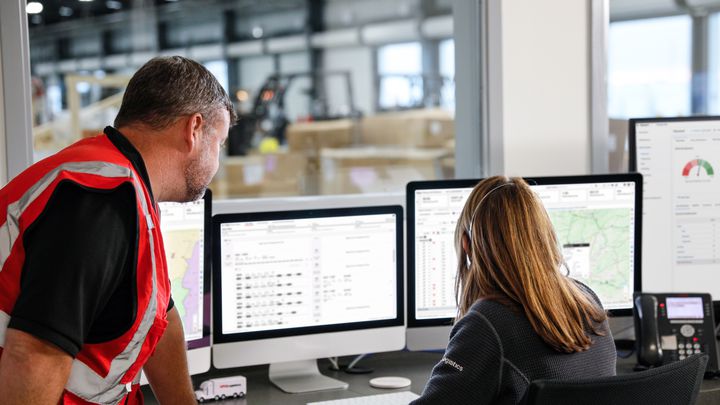 Two employees looking at a computer