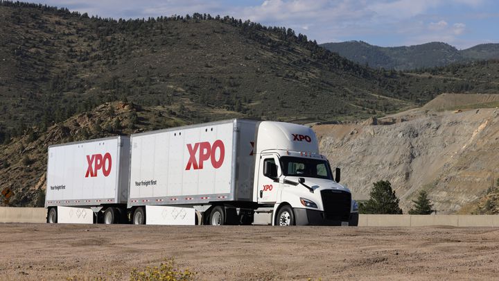 XPO double trailer with mountains in the background