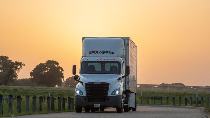 XPO truck on road during brilliant sunset