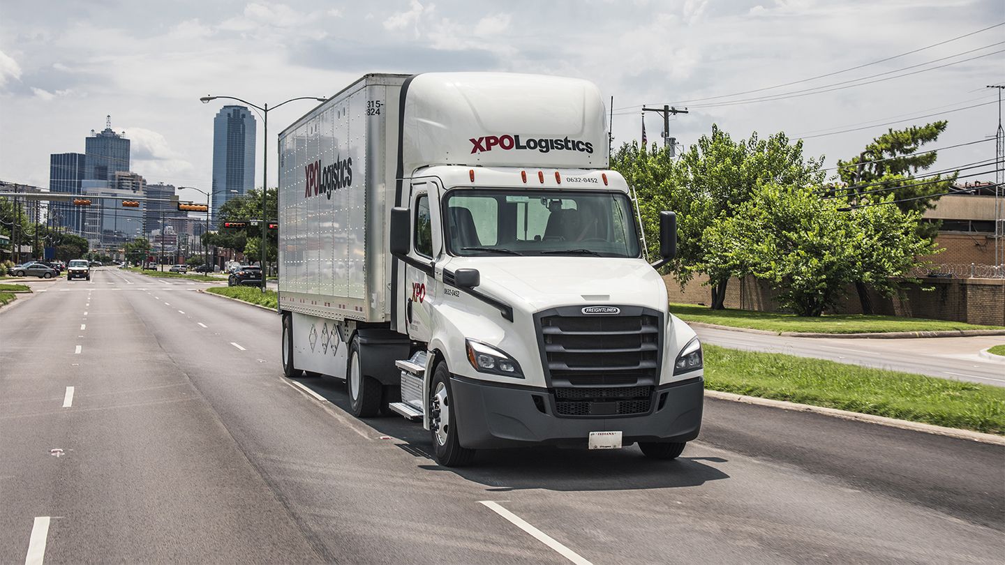 XPO truck driving on road.